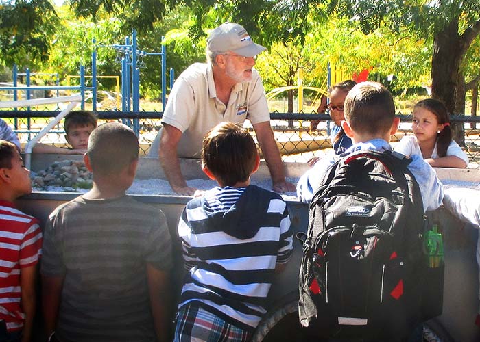 Conservation Project - Healthy Watersheds Project Highlight - Students gather at the Rolling River Watershed Model - Share with Wildlife NMDGF