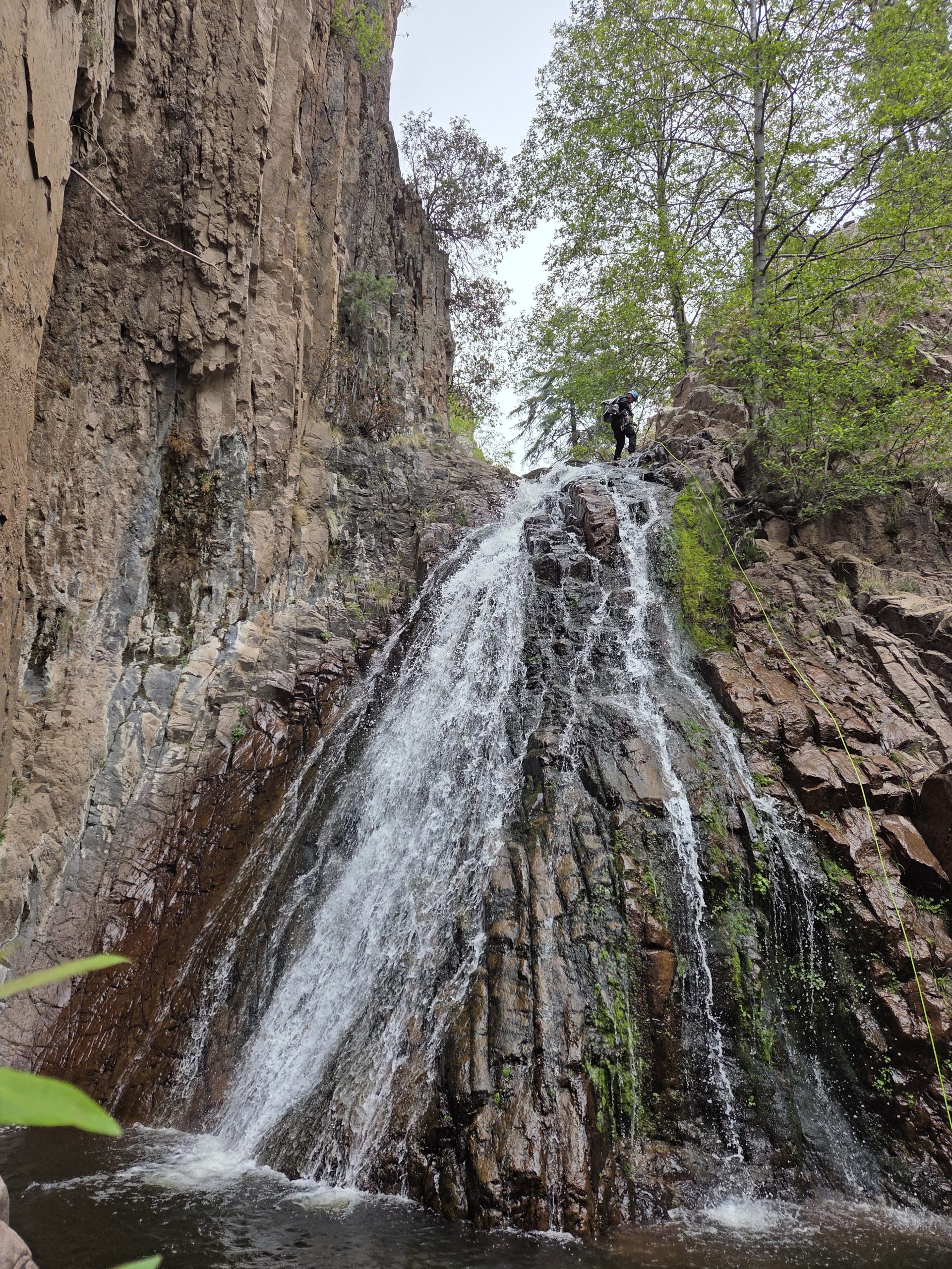 Rappelling from the top of a waterfall