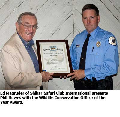 NMDGF Archive News: Ed Magruder of Shikar-Safari Club International presents Phil Howes with the Wildlife Conservation Officers of the Year Award.