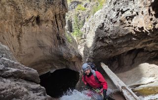 Man at the top of a steep waterfall